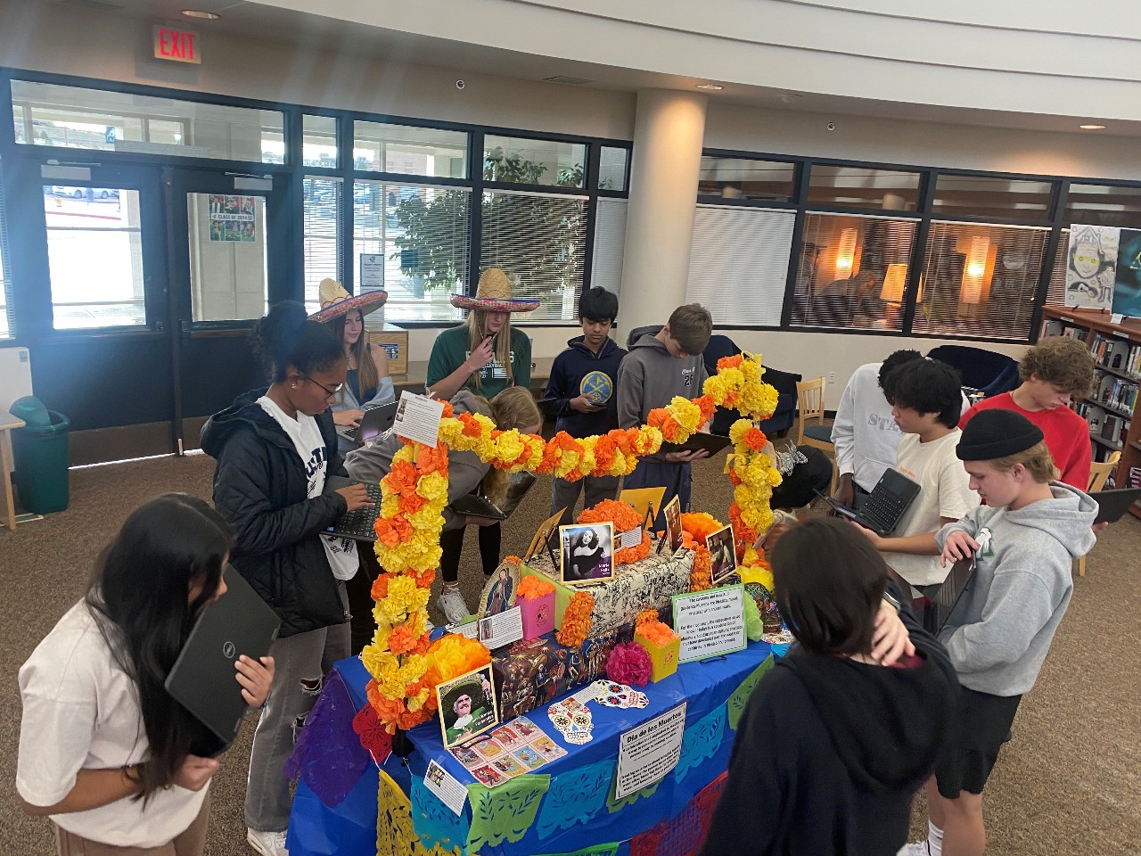 Students gathered around the Ofrenda for Dia de lost Muertos